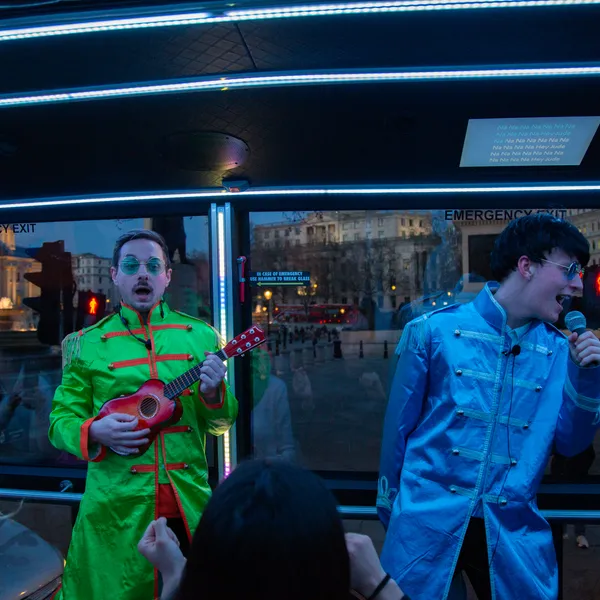 Two performers in sixties band jackets on board